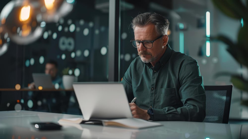 A founder at a laptop with an AI assistant, email and calendar tools open, working through the day's admin
