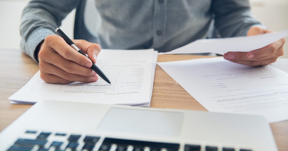 A ceo checking a pile of paperwork at his desk