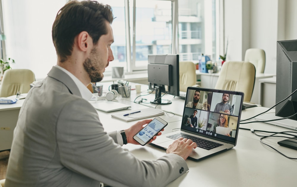 A business leader engaging in a strategic planning session via video call with a professional remote executive assistant.