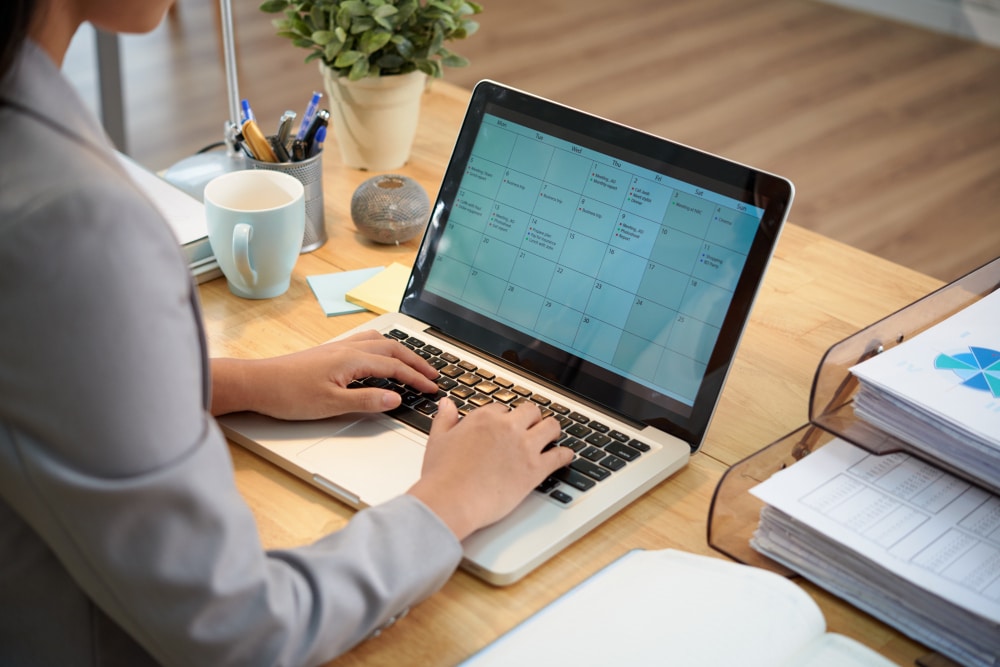 An executive assistant using AI tools on a laptop to manage a founder's inbox, calendar and priorities