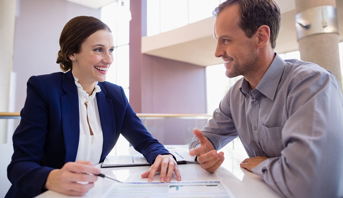 Executive Assistant and Business Owner discussing over document