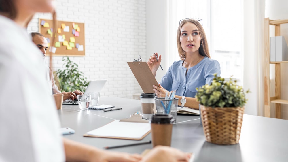 Executive assistant candidate asking thoughtful questions during interview to evaluate opportunity