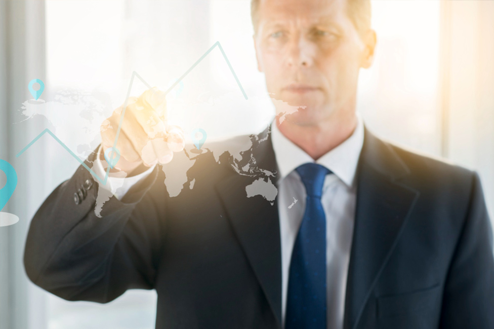 A business executive analyzing a digital data map and bar chart showing executive assistant salary differences across European countries and the USA.