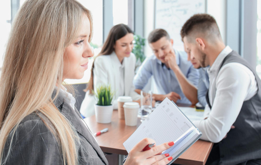 Close-up of a business executive reviewing a partnership agreement and shaking hands with a recruitment agency representative, symbolizing the choice between direct hiring and outsourced support.