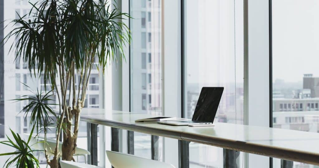 An open-plan office floor of administrative and support workers, representing white-collar support work